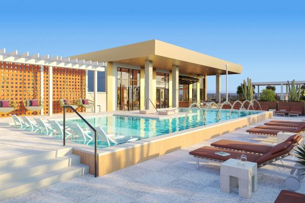 Rooftop pool at VERVE Tempe featuring modern lounge chairs, sleek glass railings, and a shaded pavilion with panoramic views—perfect for relaxing or entertaining above the city.