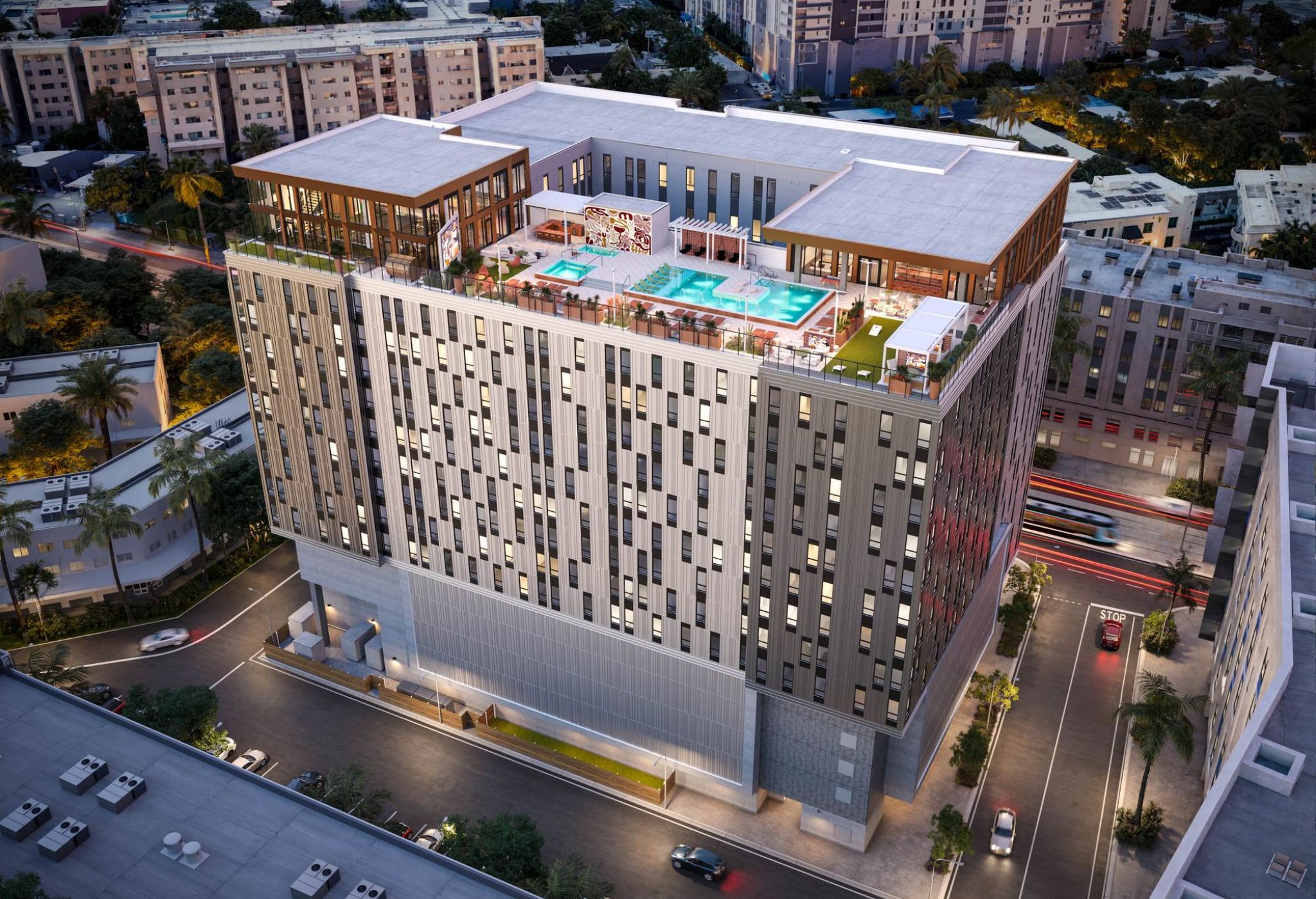 Aerial view of VERVE Tempe at dusk, showcasing its rooftop pool deck, modern architecture, and vibrant city surroundings.