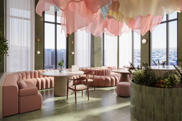 Chic lounge space at VERVE Tempe featuring blush-toned seating, tall windows with skyline views, and a sculptural pink ceiling installation that adds a playful, artistic flair to the modern interior.